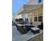Back patio with comfortable lounge seating, fire table, retractable awning, and beautiful outdoor living space at 2132 Royal Berry Ct, Cary, NC 27511