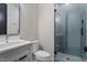 Bathroom features a glass shower, white vanity, mirror, and toilet at 226 Woodsborough Pl, Raleigh, NC 27601