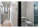 Modern bathroom featuring a glass-door shower, toilet, and vanity with white countertop at 226 Woodsborough Pl, Raleigh, NC 27601