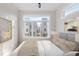 Bright bedroom with a large window providing ample natural light, neutral tones, and minimalist decor at 226 Woodsborough Pl, Raleigh, NC 27601