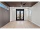 Bedroom boasts a modern ceiling fan, hardwood floors, and natural light from a window and double doors at 226 Woodsborough Pl, Raleigh, NC 27601