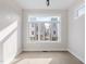 An empty bedroom provides a spacious feel with an oversized window at 226 Woodsborough Pl, Raleigh, NC 27601
