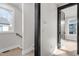 Hallway featuring hardwood floors, white walls and trim, and black door frames at 226 Woodsborough Pl, Raleigh, NC 27601