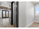 Well-lit hallway with sleek black trim, a light hardwood floor, and views of a bedroom with a ceiling fan at 226 Woodsborough Pl, Raleigh, NC 27601