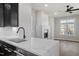 Bright kitchen with quartz countertops, black cabinets, and stainless steel appliances provides a modern aesthetic at 226 Woodsborough Pl, Raleigh, NC 27601