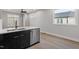 Contemporary kitchen with stainless steel dishwasher, black lower cabinets, and quartz countertop at 226 Woodsborough Pl, Raleigh, NC 27601
