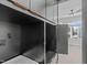 Laundry room with black cabinets and view of a bedroom with a large window at 226 Woodsborough Pl, Raleigh, NC 27601