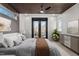 Relaxing bedroom featuring a wood slat ceiling, a comfy bed, and a view of the city through large windows at 226 Woodsborough Pl, Raleigh, NC 27601