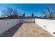 Expansive rooftop deck with wood-look tiles, offering stunning city views and private outdoor space for entertaining at 226 Woodsborough Pl, Raleigh, NC 27601
