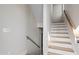 Stairway featuring hardwood treads and handrail and white risers and walls at 226 Woodsborough Pl, Raleigh, NC 27601