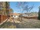 Large backyard featuring a wooden fence, mature trees, and a lawn at 23 Juliette Dr, Durham, NC 27713