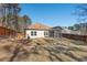 Backyard featuring a wooden fence, mature trees, and a screened in porch at 23 Juliette Dr, Durham, NC 27713
