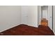 Bedroom featuring hardwood floors, neutral paint, and a paneled door at 23 Juliette Dr, Durham, NC 27713