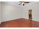 Bright bedroom featuring hardwood floors, a tray ceiling, and an en-suite bathroom at 23 Juliette Dr, Durham, NC 27713