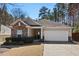 Charming home featuring a stone facade, attached two-car garage, and well-manicured front yard at 23 Juliette Dr, Durham, NC 27713
