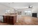Open-concept living room with fireplace, ceiling fan, and sliding glass door to the screened porch at 23 Juliette Dr, Durham, NC 27713