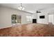 Bright living room featuring a fireplace, ceiling fan, and access to the screened-in porch at 23 Juliette Dr, Durham, NC 27713