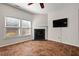 Cozy living room with a fireplace and ample natural light from the windows at 23 Juliette Dr, Durham, NC 27713
