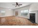 Comfortable living space featuring a fireplace, ceiling fan, and sliding glass door to screened porch at 23 Juliette Dr, Durham, NC 27713