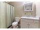 Bathroom with a shower, toilet, and vanity with a white marble top and white cabinets at 2425 Shreve Rd, Rocky Mount, NC 27801