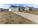 A single-story home with a white exterior, attached garage, and a long driveway at 2425 Shreve Rd, Rocky Mount, NC 27801