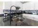 Well-lit kitchen featuring white cabinets, stainless steel appliances, and dark countertops at 2425 Shreve Rd, Rocky Mount, NC 27801