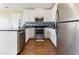 Well-lit kitchen featuring white cabinets, stainless steel appliances, and dark countertops at 2425 Shreve Rd, Rocky Mount, NC 27801