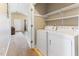 Convenient laundry room with washer, dryer, and shelving for storage at 2425 Shreve Rd, Rocky Mount, NC 27801