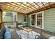 Outdoor back deck area includes wood pergola, stylish seating, and double glass doors to the home's interior at 2511 State St, Durham, NC 27704