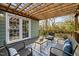 Outdoor deck with comfortable seating under a pergola offers a perfect spot for relaxation and outdoor entertaining at 2511 State St, Durham, NC 27704