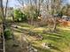 An elevated view of the spacious backyard, showcasing the mature trees and landscaping at 2511 State St, Durham, NC 27704