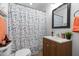 Cozy bathroom with a polka dot shower curtain, vanity with sink, and wall cabinet maximizes functionality at 2511 State St, Durham, NC 27704