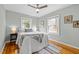 This sunlit bedroom offers a comfortable bed, hardwood floors, neutral walls, and modern decor for a relaxing retreat at 2511 State St, Durham, NC 27704