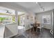 Charming dining area featuring a rustic wooden table and a view into the cozy living room and back patio at 2511 State St, Durham, NC 27704