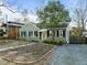 Charming green bungalow with black shutters and a welcoming front yard, offering classic curb appeal at 2511 State St, Durham, NC 27704