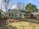 Attractive bungalow with a well-maintained lawn, enhanced by mature trees and beautiful natural light at 2511 State St, Durham, NC 27704