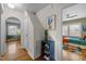 Bright hallway with hardwood floors, stylish decor, and access to the bedroom offers a warm and inviting atmosphere at 2511 State St, Durham, NC 27704