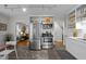 Bright kitchen with stainless steel appliances and open shelving, seamlessly connected to the living room at 2511 State St, Durham, NC 27704