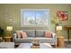 Cozy living room with a gray sofa, natural light, and decorative accents at 2511 State St, Durham, NC 27704