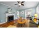 Inviting living room featuring a fireplace, ceiling fan, hardwood floors and comfortable seating at 2511 State St, Durham, NC 27704