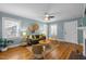 Bright and airy living room featuring natural light, hardwood floors, and a ceiling fan at 2511 State St, Durham, NC 27704
