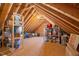 Spacious attic with wooden beams and ample storage space filled with bins and other items at 27 Ellen Cir, Clayton, NC 27527