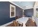 Inviting back porch with a ceiling fan and wood table set for outdoor dining and enjoying backyard views at 27 Ellen Cir, Clayton, NC 27527