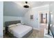Bedroom with angled ceilings, bed and tv and adjoining room at 27 Ellen Cir, Clayton, NC 27527