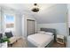 Bedroom with angled ceilings, bed and chair with side table at 27 Ellen Cir, Clayton, NC 27527