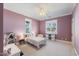 Cozy bedroom with purple walls, white trim and a comfortable bed at 27 Ellen Cir, Clayton, NC 27527