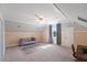 Bonus room with large carpet area, sofa, desk and natural light at 27 Ellen Cir, Clayton, NC 27527