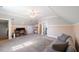 Bonus room with large carpet area, sofa and desk with dual monitors at 27 Ellen Cir, Clayton, NC 27527
