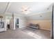 Bonus room with large carpet area, sofa and natural light at 27 Ellen Cir, Clayton, NC 27527