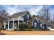Charming navy-blue home with a welcoming front porch and beautifully landscaped yard at 27 Ellen Cir, Clayton, NC 27527